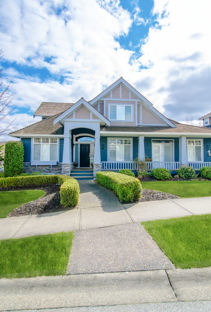 beautiful-blue-house-exterior-with-manicured-lawn