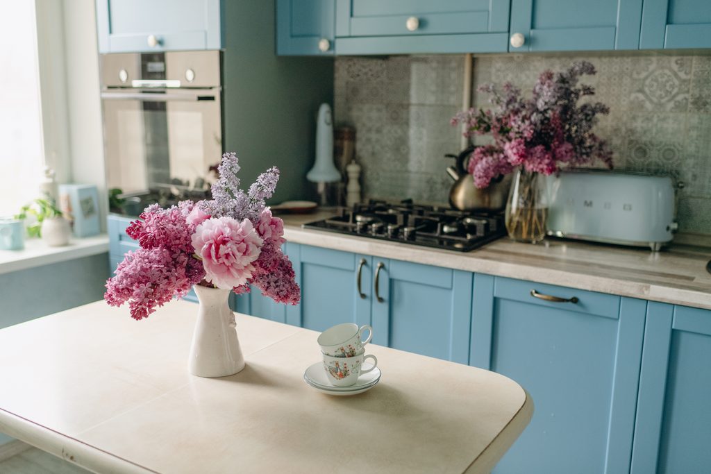 Floral Arrangement and Teacups in Blue Kitchen