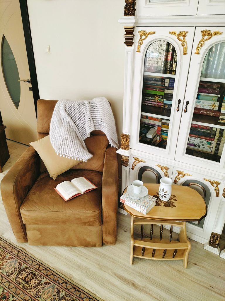 Inviting reading nook with a brown armchair, open book, and elegant bookshelf. The 30/30 Rule